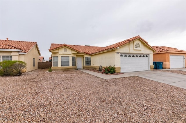 2595 Fort Lauderdale Dr, Las Vegas, NV 89156 - mediterranean / spanish home featuring a garage, driveway, stucco siding, and a tiled roof