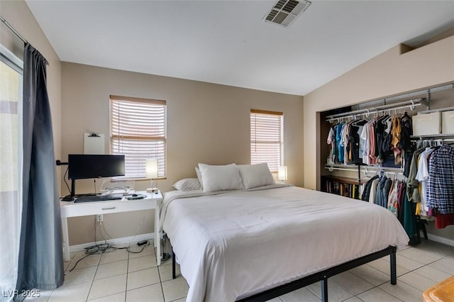 2595 Fort Lauderdale Dr, Las Vegas, NV 89156 - tiled bedroom with multiple windows, a closet, vaulted ceiling, baseboards, and an office area