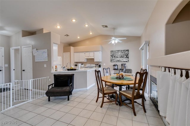 2595 Fort Lauderdale Dr, Las Vegas, NV 89156 - dining area featuring vaulted ceiling, ceiling fan, light tile patterned floors, arched walkways, and recessed lighting