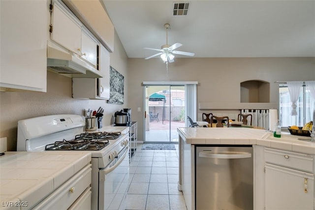 2595 Fort Lauderdale Dr, Las Vegas, NV 89156 - kitchen featuring white range with gas cooktop, dishwasher, tile counters, under cabinet range hood, and ceiling fan
