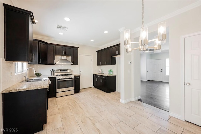 kitchen featuring stainless steel range with gas stovetop, visible vents, ornamental molding, and a sink