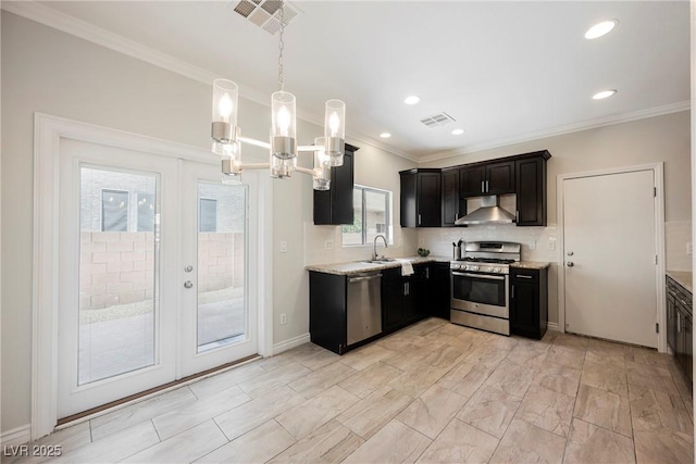 kitchen with visible vents, ornamental molding, appliances with stainless steel finishes, and wall chimney range hood