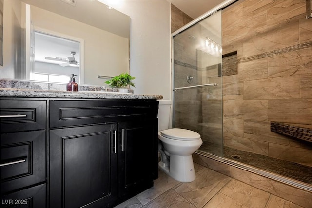full bathroom with ceiling fan, vanity, toilet, marble finish floor, and a shower stall