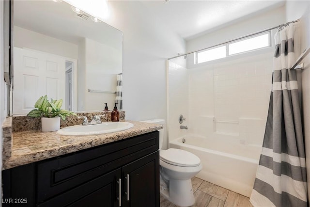 bathroom with toilet, shower / bathtub combination with curtain, and vanity