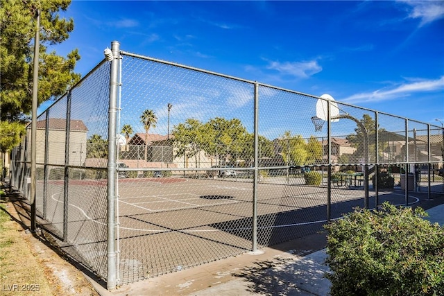 view of sport court featuring fence