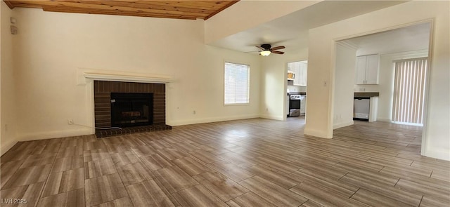 4308 Apex Dr, Las Vegas, NV 89147 - unfurnished living room with a brick fireplace, light wood-style flooring, ceiling fan, and baseboards