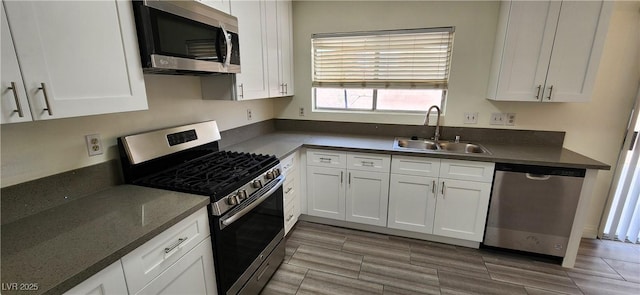 4308 Apex Dr, Las Vegas, NV 89147 - kitchen featuring a sink, white cabinetry, dark countertops, and stainless steel appliances