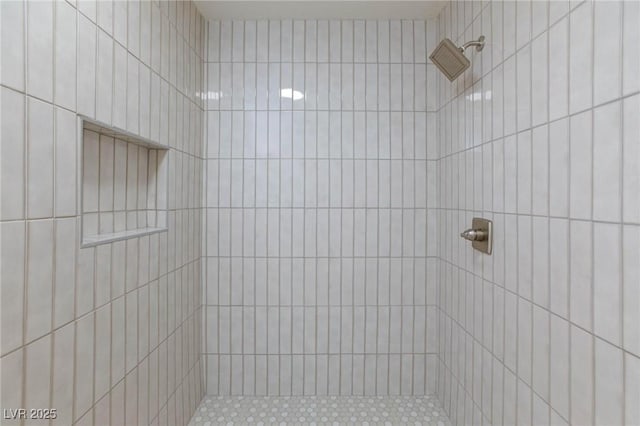 bathroom featuring a tile shower