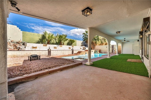 view of patio / terrace featuring a fenced in pool, a fenced backyard, and an outdoor fire pit
