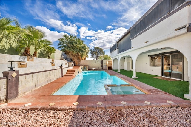 view of pool featuring a patio, a pool with connected hot tub, and a fenced backyard