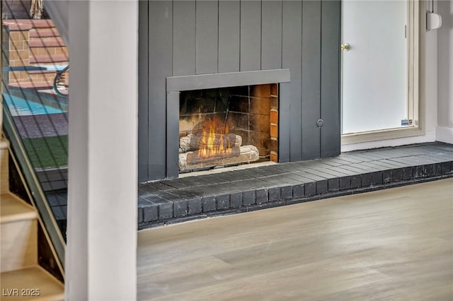 details featuring a fireplace and wood finished floors