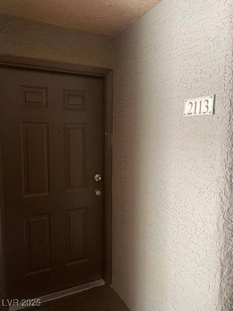 view of exterior entry featuring stucco siding