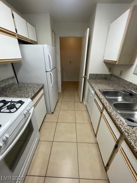 kitchen featuring white gas range, range hood, white cabinetry, a sink, and light tile patterned flooring