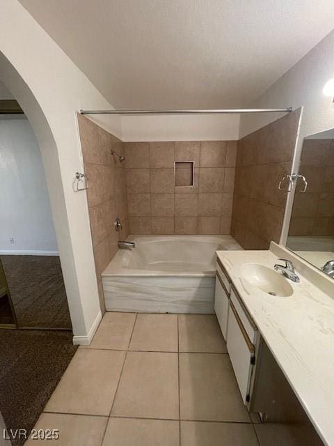 full bathroom with washtub / shower combination, tile patterned flooring, and vanity