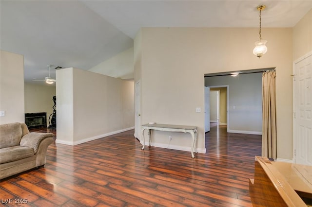living room with baseboards, ceiling fan, hardwood / wood-style flooring, and high vaulted ceiling