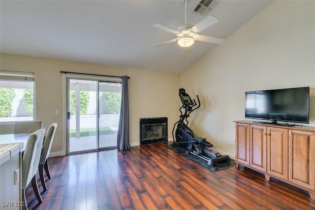 interior space featuring visible vents, baseboards, ceiling fan, dark wood finished floors, and vaulted ceiling