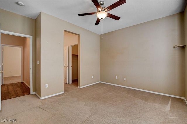 unfurnished bedroom with a ceiling fan, baseboards, and light colored carpet
