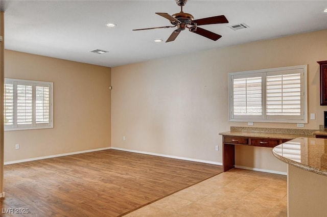 unfurnished living room with a ceiling fan, visible vents, baseboards, light wood finished floors, and recessed lighting