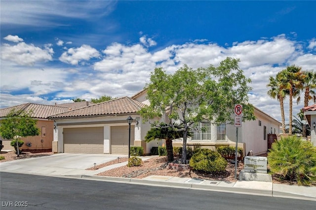 mediterranean / spanish-style home featuring a tiled roof, an attached garage, driveway, and stucco siding