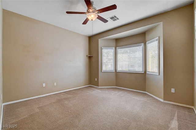 spare room featuring visible vents, baseboards, carpet floors, and ceiling fan