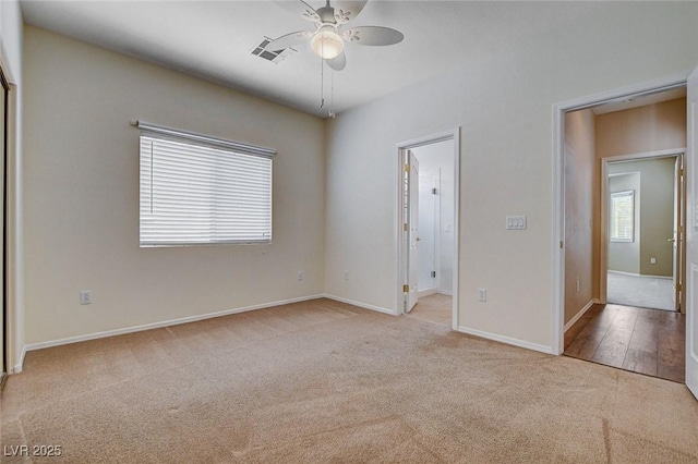 unfurnished bedroom featuring carpet floors, baseboards, a ceiling fan, and visible vents