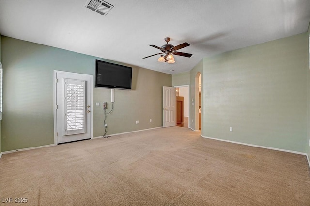 interior space with a ceiling fan, baseboards, visible vents, and light carpet