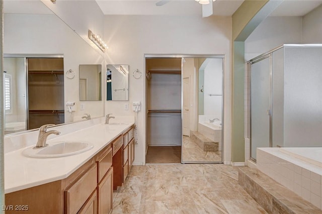 full bath featuring a sink, a walk in closet, and a bath