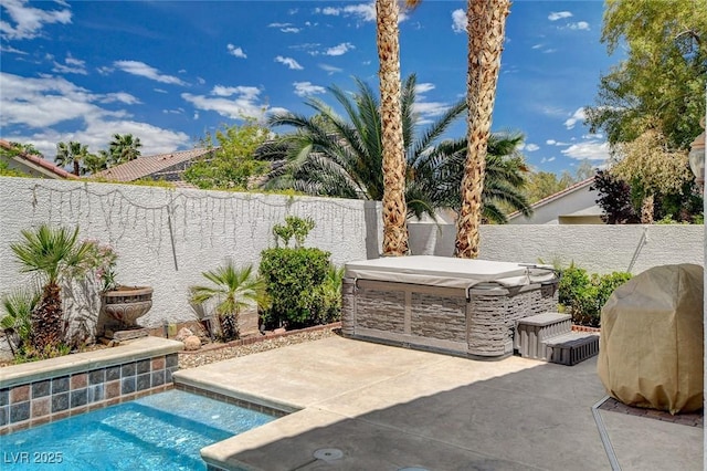 view of patio / terrace featuring a fenced backyard, a hot tub, an outdoor pool, and area for grilling