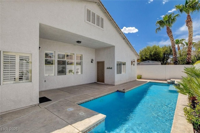 view of swimming pool with a fenced in pool, fence, and a patio area