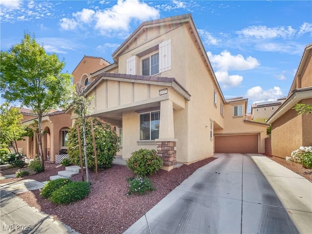 view of front of house featuring stucco siding, an attached garage, driveway, and a tiled roof