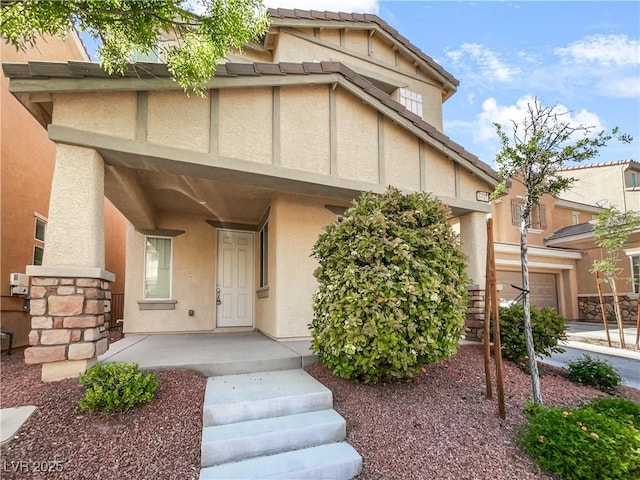 view of front of house with a garage and stucco siding