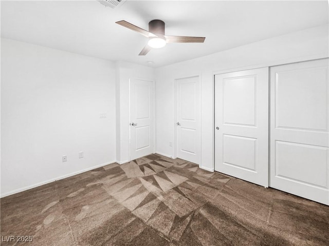 unfurnished bedroom with carpet floors, a ceiling fan, baseboards, and a closet
