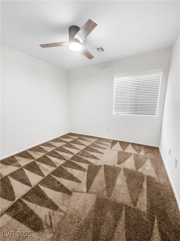 empty room featuring baseboards, ceiling fan, carpet, and visible vents