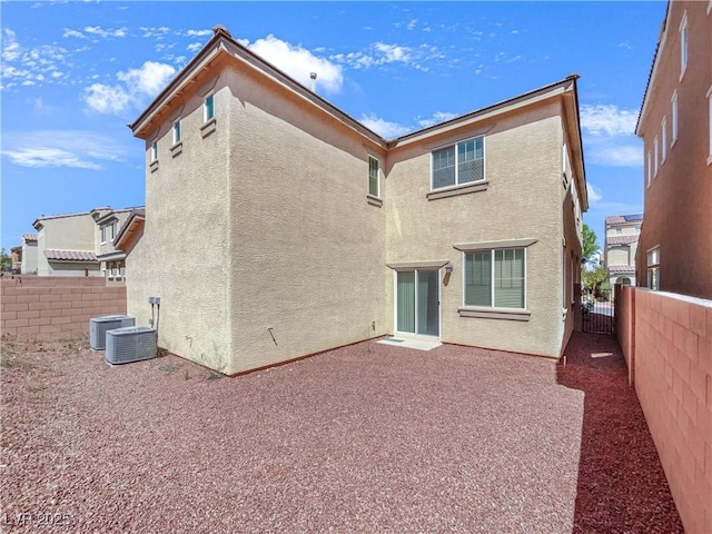 rear view of property featuring a patio, a fenced backyard, and stucco siding