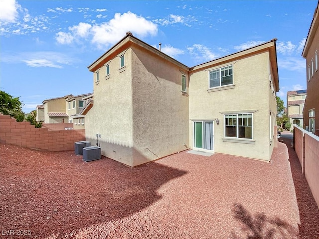 rear view of property featuring a patio, a fenced backyard, stucco siding, and cooling unit