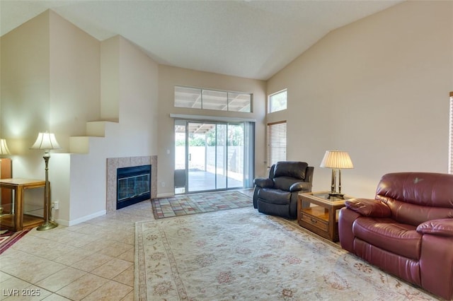 2805 Rungsted St, Las Vegas, NV 89142 - living room with a tiled fireplace, high vaulted ceiling, baseboards, and tile patterned floors