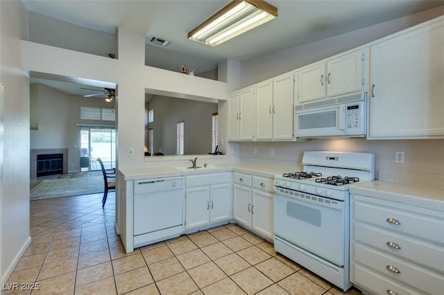2805 Rungsted St, Las Vegas, NV 89142 - kitchen featuring white cabinets, white appliances, tile countertops, a ceiling fan, and visible vents