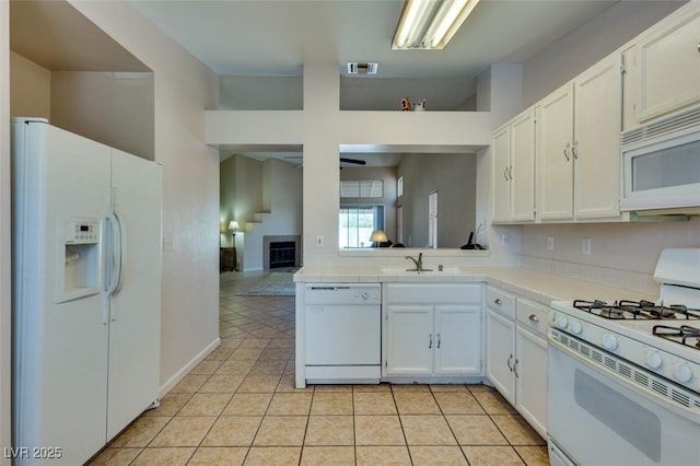 2805 Rungsted St, Las Vegas, NV 89142 - kitchen with visible vents, a sink, light tile patterned floors, white cabinets, and white appliances