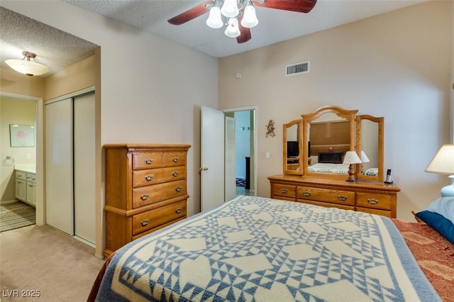 2805 Rungsted St, Las Vegas, NV 89142 - bedroom featuring a ceiling fan, visible vents, a closet, light carpet, and ensuite bath