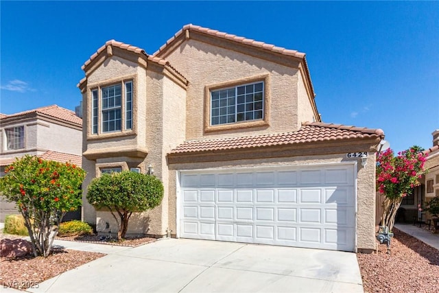6428 Yarmouth Dr, Las Vegas, NV 89108 - view of front of home featuring a tiled roof, driveway, and stucco siding
