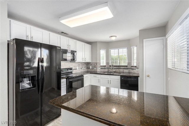 6428 Yarmouth Dr, Las Vegas, NV 89108 - kitchen featuring backsplash, a sink, black appliances, dark stone countertops, and white cabinetry