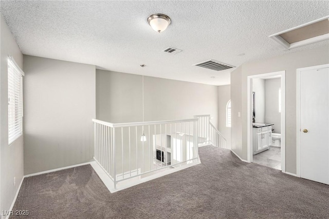 6428 Yarmouth Dr, Las Vegas, NV 89108 - hall featuring plenty of natural light, an upstairs landing, carpet flooring, and visible vents