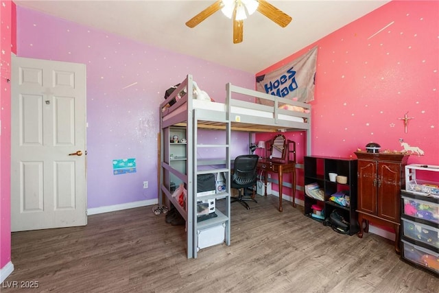 bedroom featuring baseboards, ceiling fan, and wood finished floors