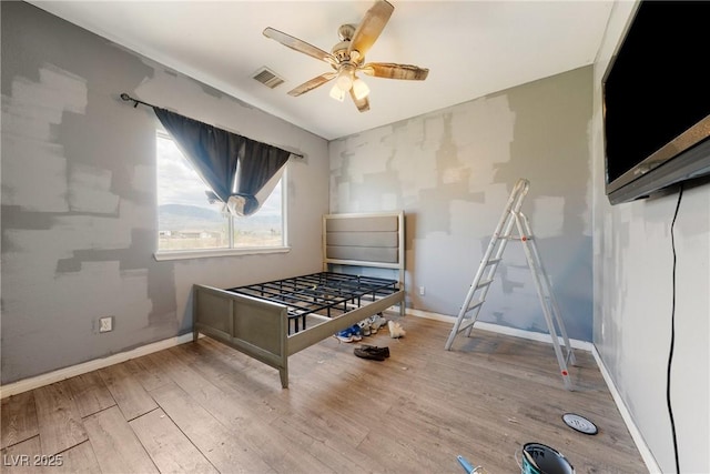 recreation room with a ceiling fan, baseboards, visible vents, and wood finished floors