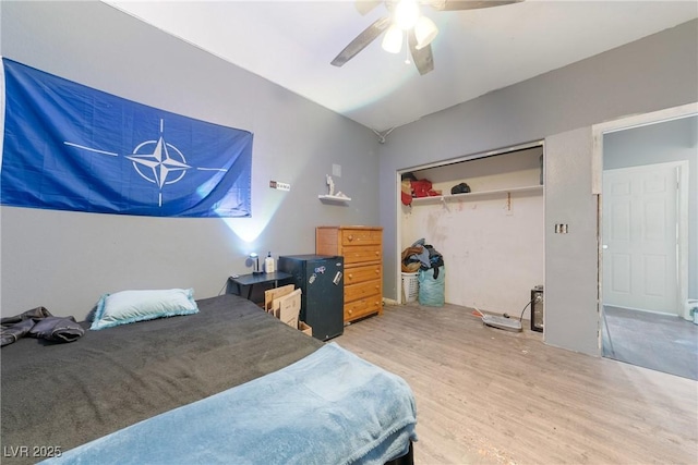 bedroom featuring ceiling fan, a closet, and wood finished floors