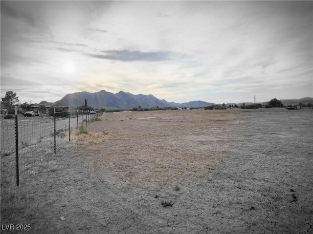 view of yard featuring fence and a mountain view