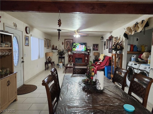 dining area with washer and dryer, light tile patterned flooring, and ceiling fan