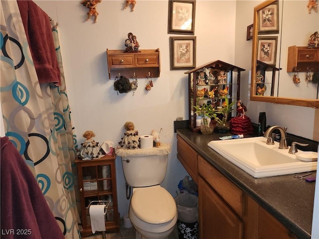 bathroom featuring vanity, toilet, and a shower with curtain