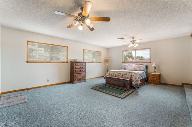 bedroom with baseboards, a textured ceiling, and carpet