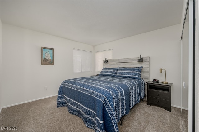 carpeted bedroom featuring baseboards